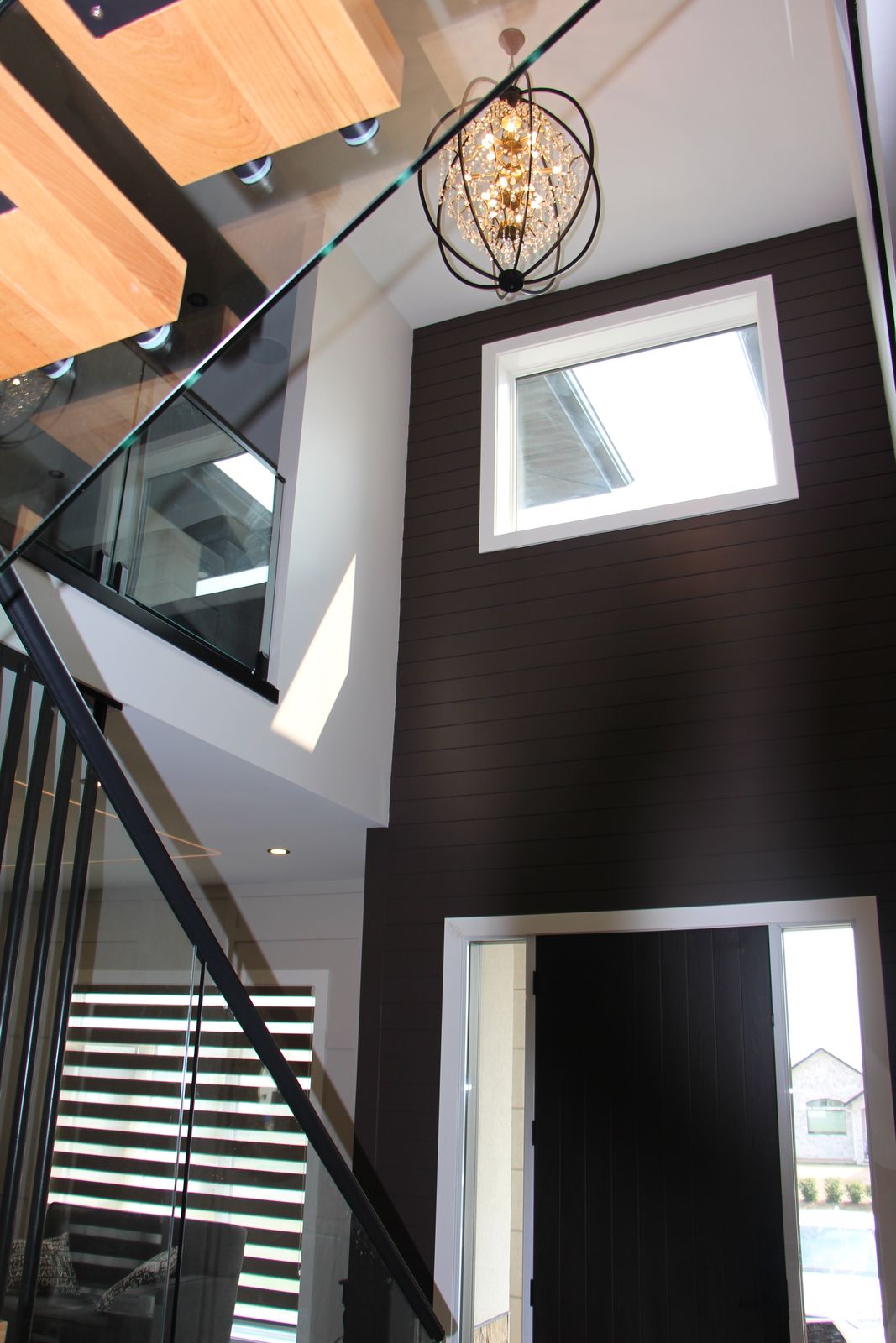 Double-height entry with dark feature wall and clerestory windows